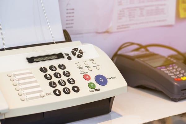 Image of old fax machine on a desk Image of old fax machine on a desk