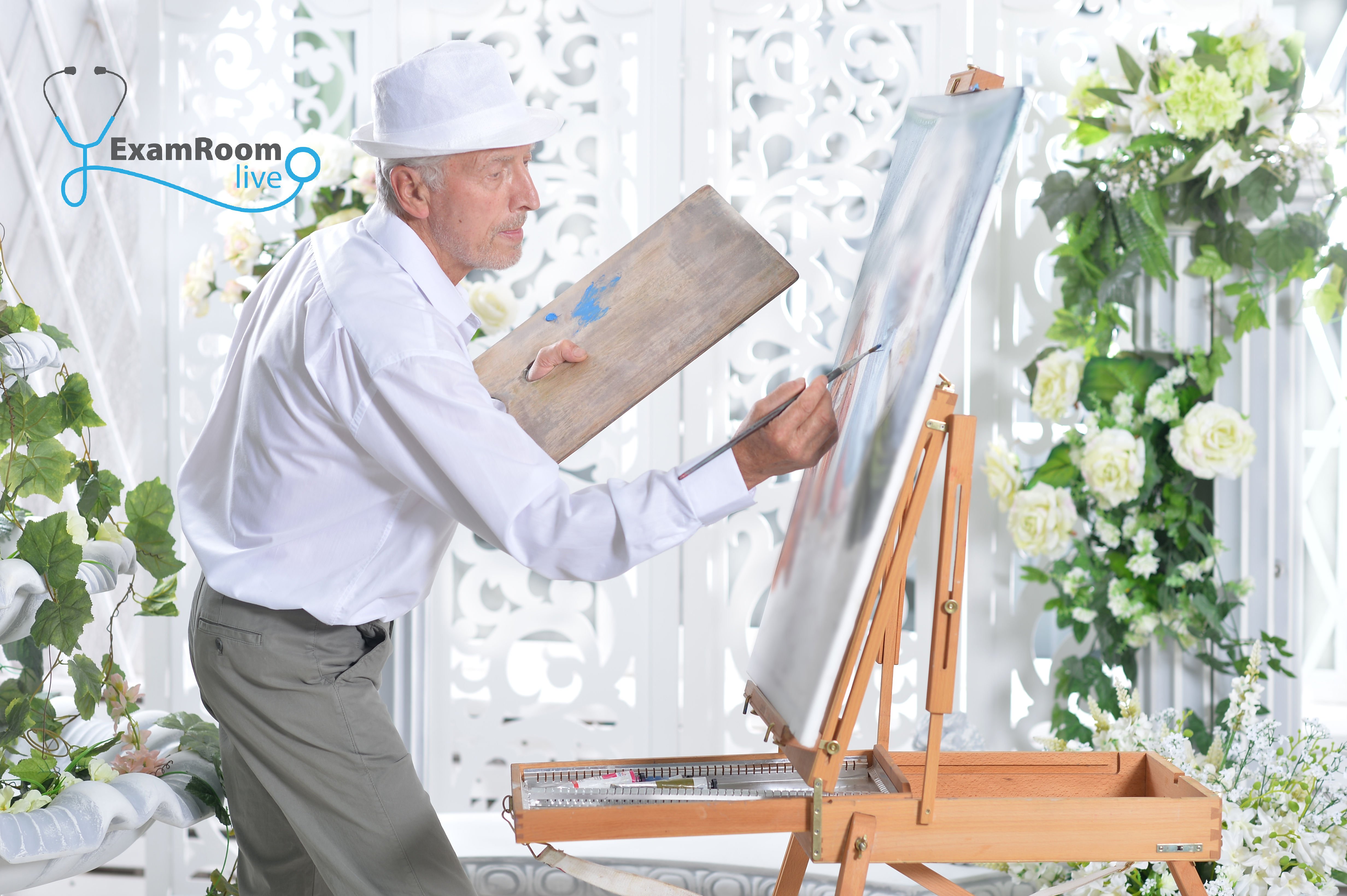 Picture of a guy painting on canvas.